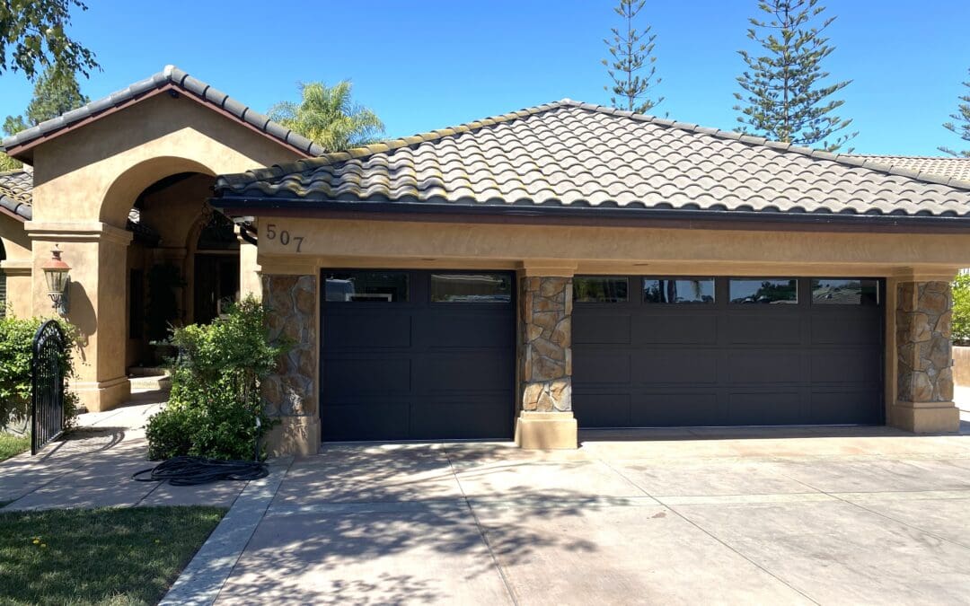 Modern garage door openers installation in a Stevenson Ranch home by Archway Garage Doors, featuring a sleek smart design integrated with durable blue torsion springs and heavy-duty tracks.